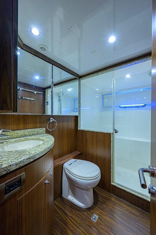 a bathroom with a sink toilet and a mirror aboard ONE SHOT Yacht for Sale