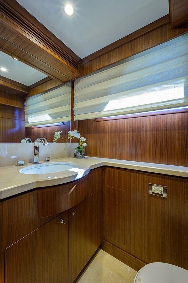 a bathroom with wooden cabinets aboard ONE SHOT Yacht for Sale