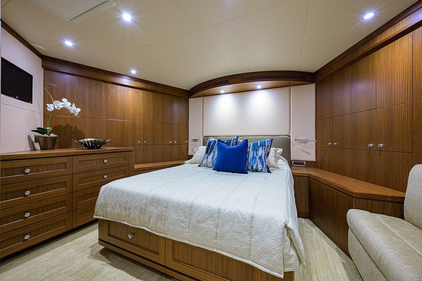 a bedroom with a bed and a couch aboard ONE SHOT Yacht for Sale