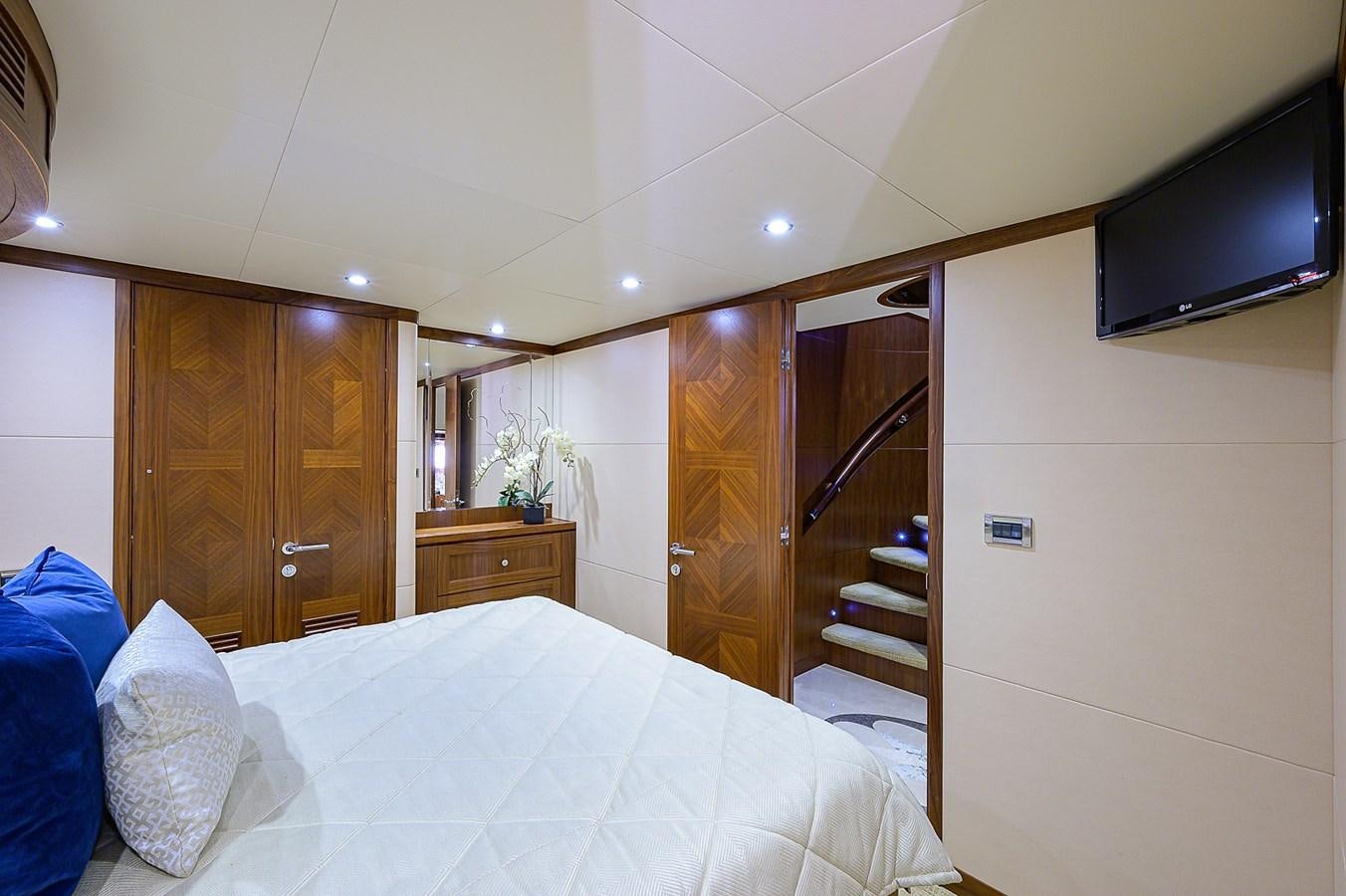 a bed and a television in a room aboard ONE SHOT Yacht for Sale