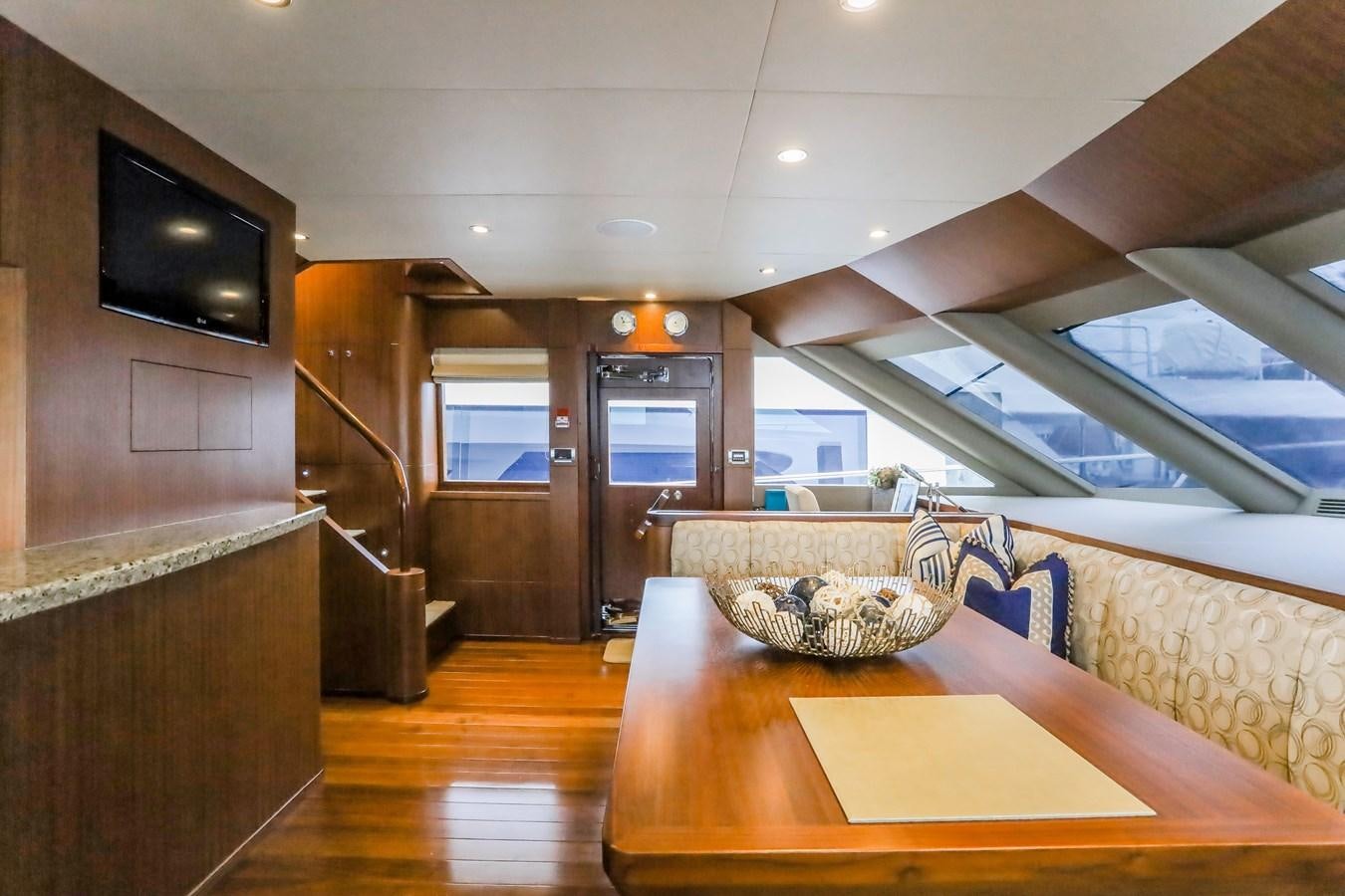 a room with a table and tv aboard ONE SHOT Yacht for Sale