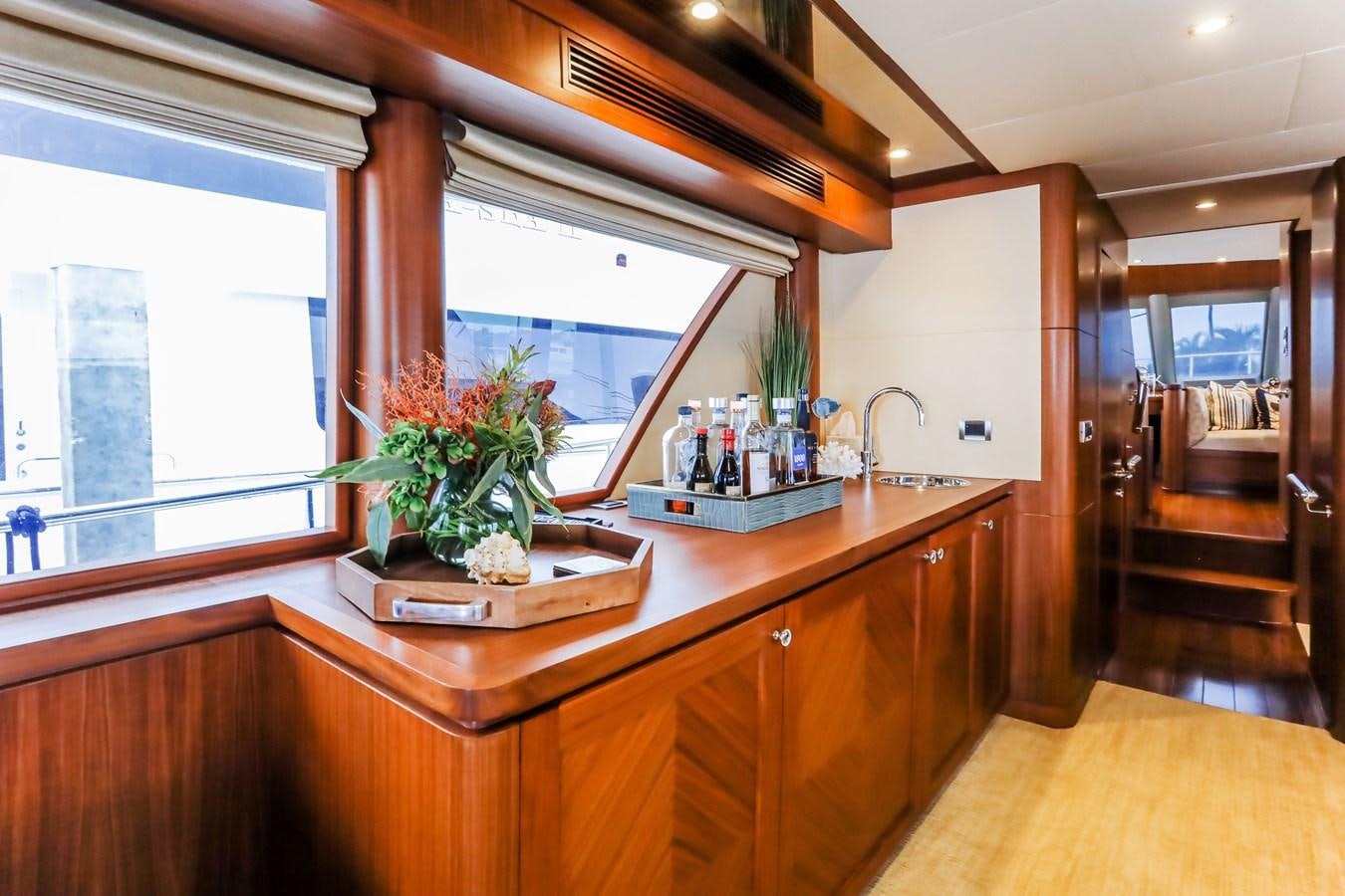 a kitchen with a countertop sink and a plant on a tray aboard ONE SHOT Yacht for Sale