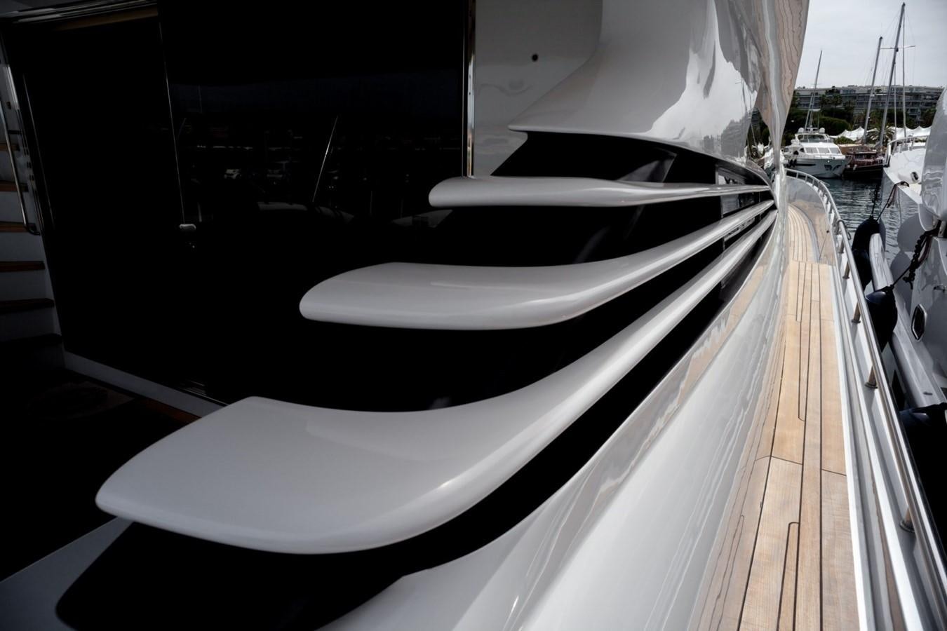 a white chair on a balcony aboard A&O Yacht for Sale