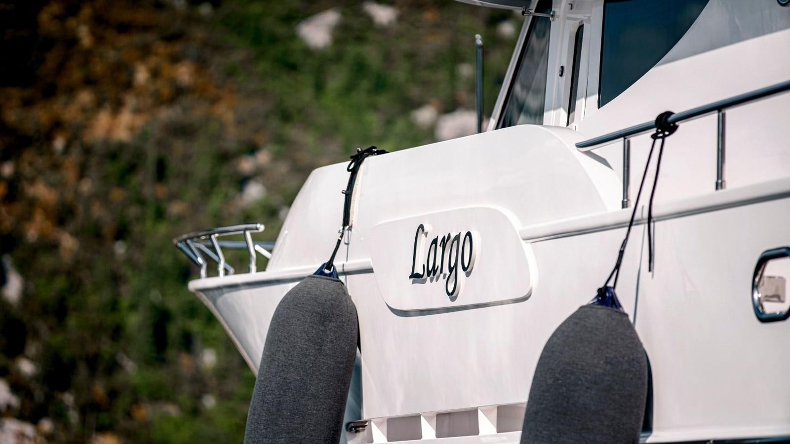 a white car with a black tire aboard LARGO Yacht for Sale