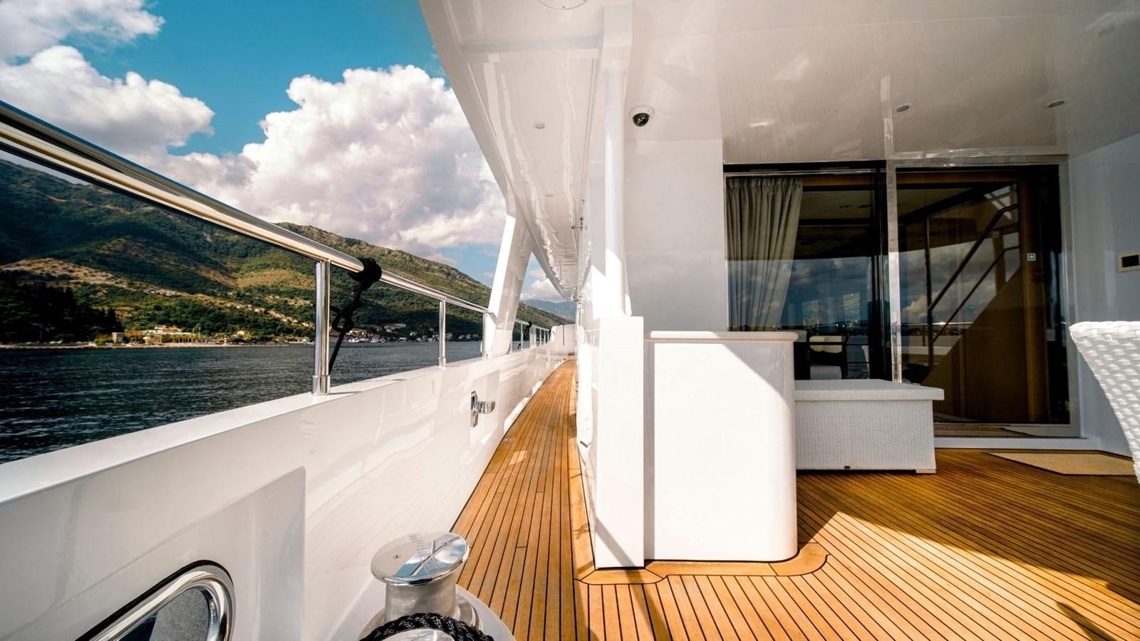 a room with a large window and a wood floor aboard LARGO Yacht for Sale