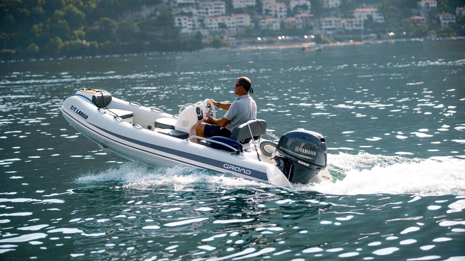 a man driving a jet ski aboard LARGO Yacht for Sale