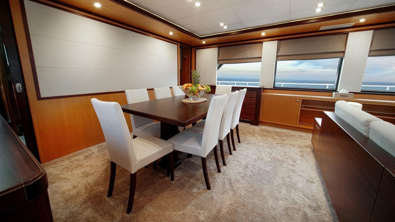 a conference room with a table and chairs aboard LARGO Yacht for Sale