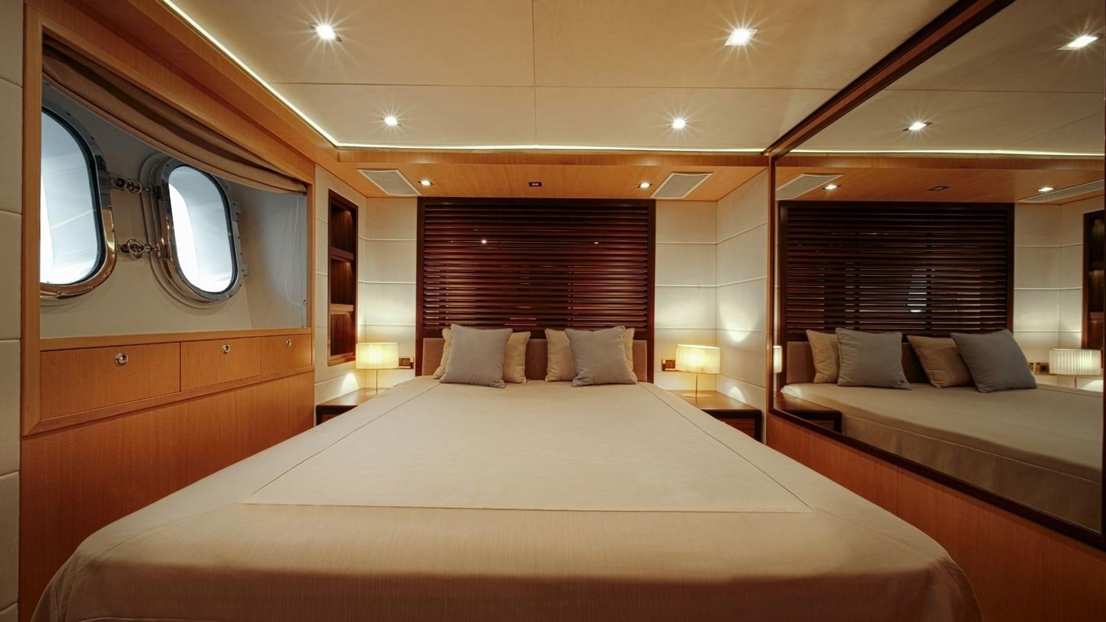 a large bed in a room aboard LARGO Yacht for Sale