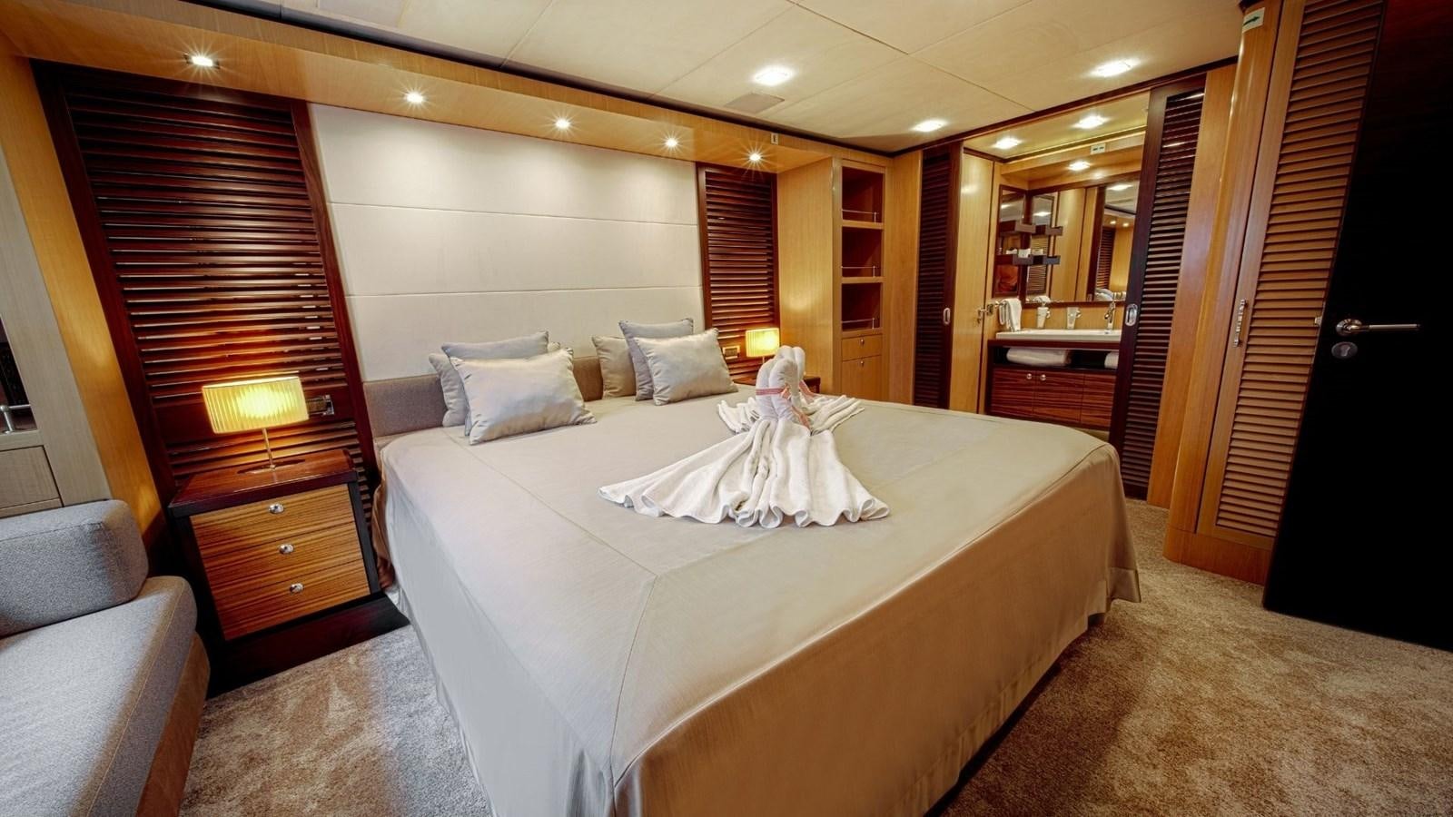 a large hotel room with a large bed and a desk aboard LARGO Yacht for Sale