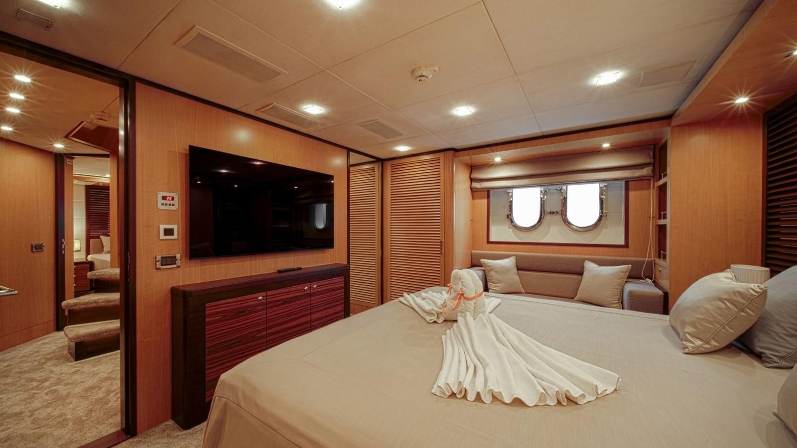 a hotel room with a bed and a tv aboard LARGO Yacht for Sale