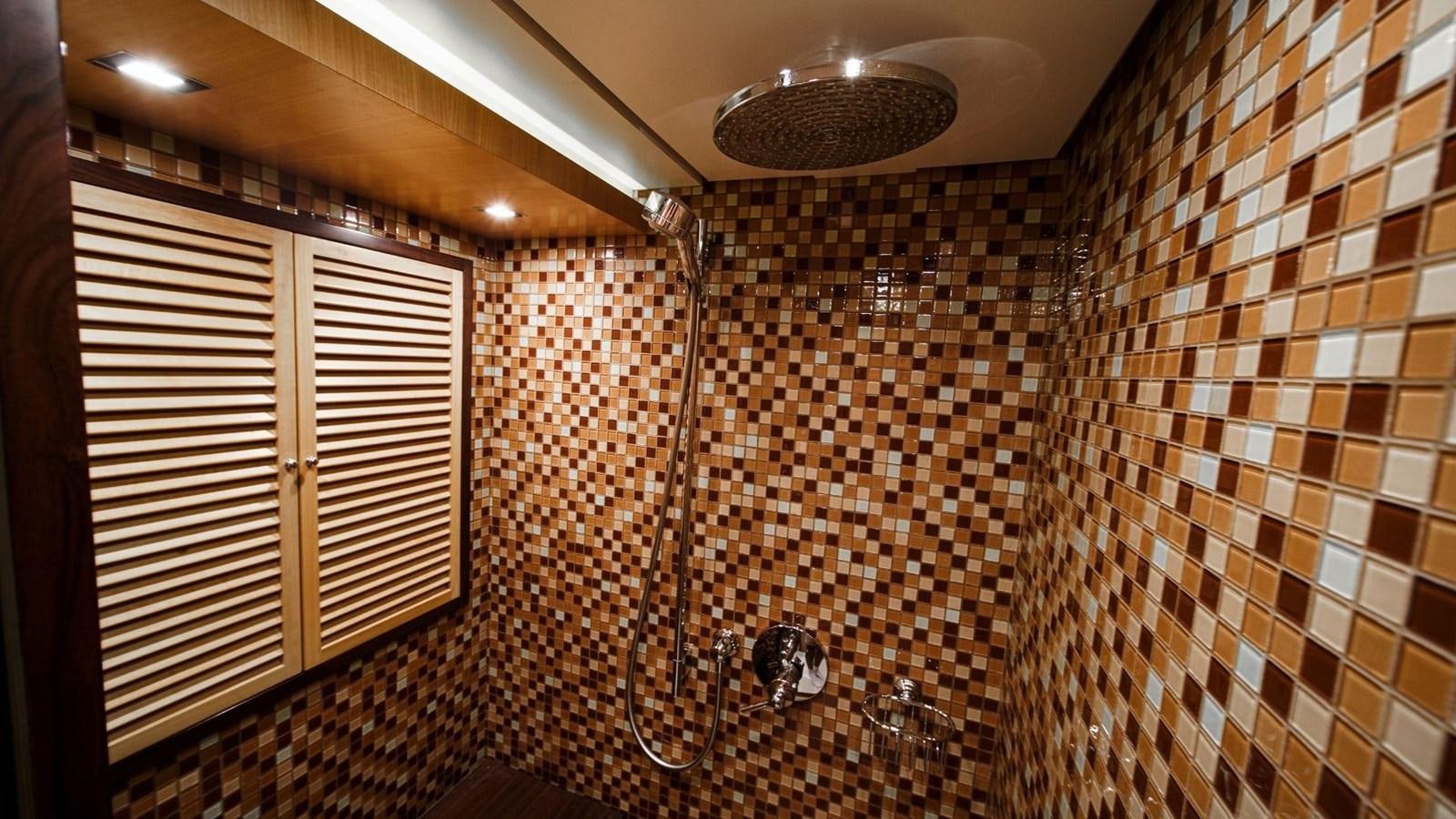 a bathroom with a shower unit and a sink aboard LARGO Yacht for Sale