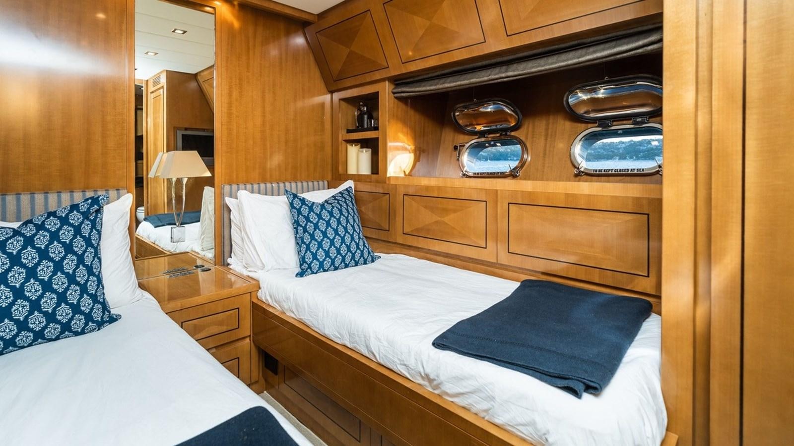 a room with a bed and a dresser aboard PALOMA Yacht for Sale
