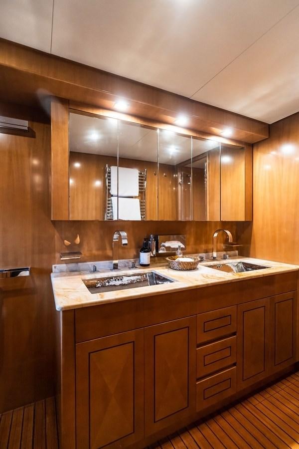 a kitchen with wooden cabinets aboard PALOMA Yacht for Sale