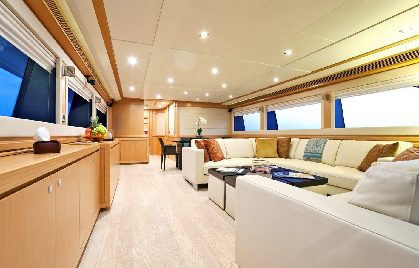 a living room with a couch and a table aboard LA PAUSA Yacht for Sale