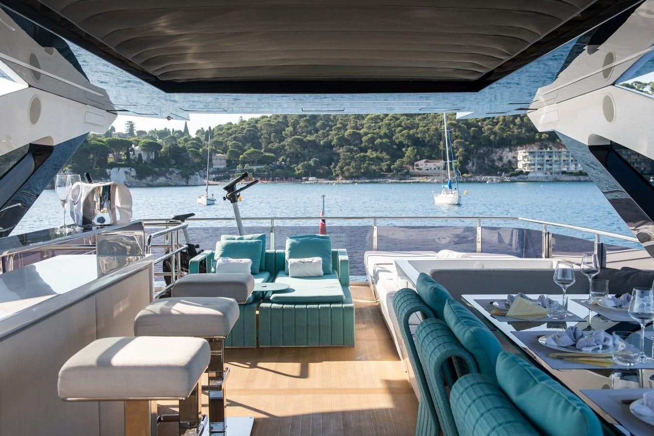 a room with a table chairs and a view of a city aboard 7 SECONDS Yacht for Sale