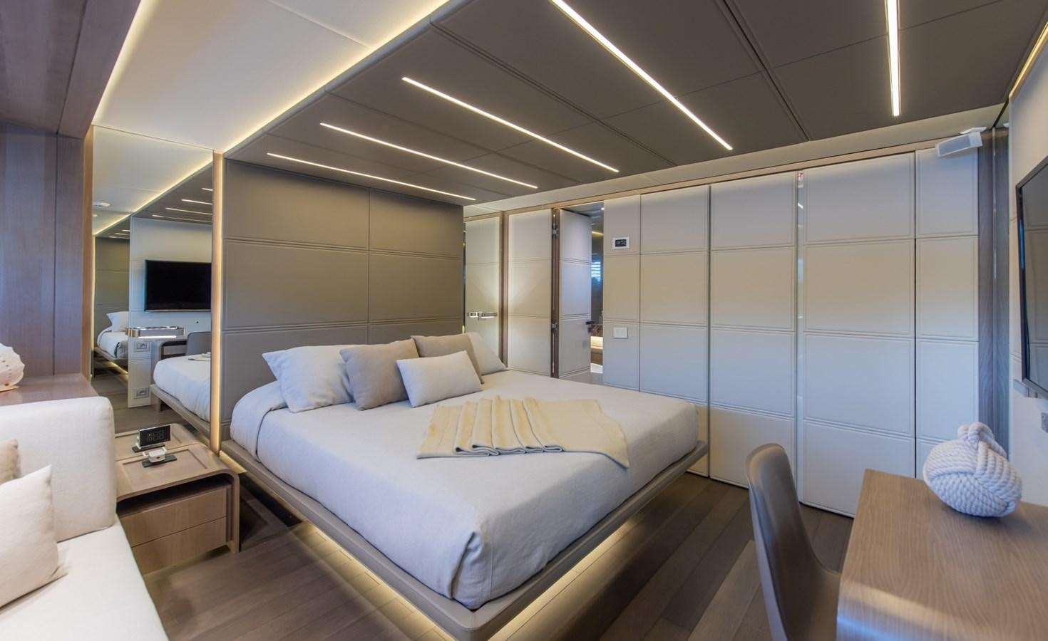 a room with a bed and a table aboard 7 SECONDS Yacht for Sale