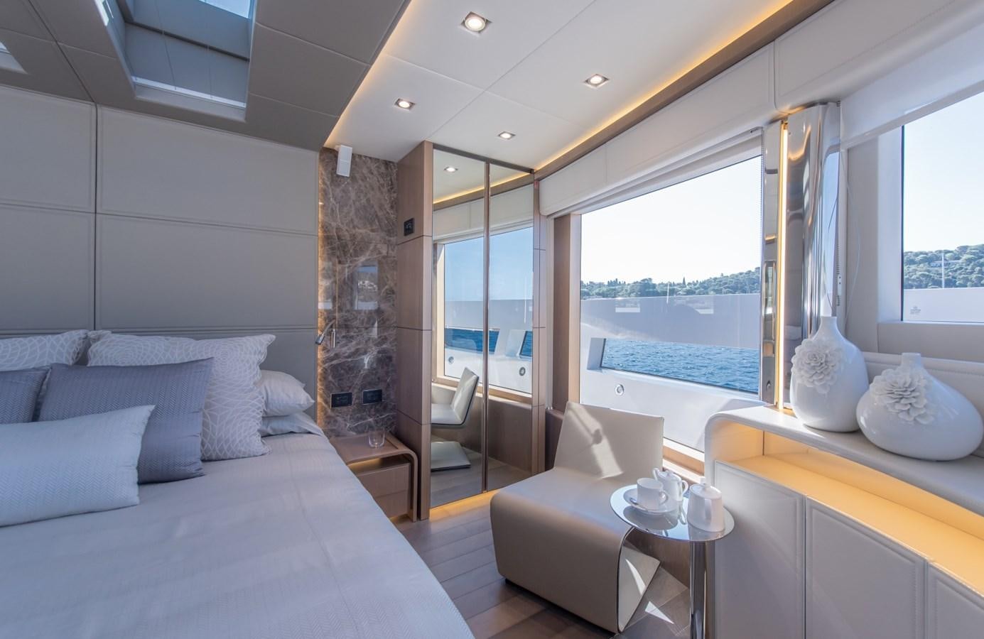 a room with a bed and a table aboard 7 SECONDS Yacht for Sale