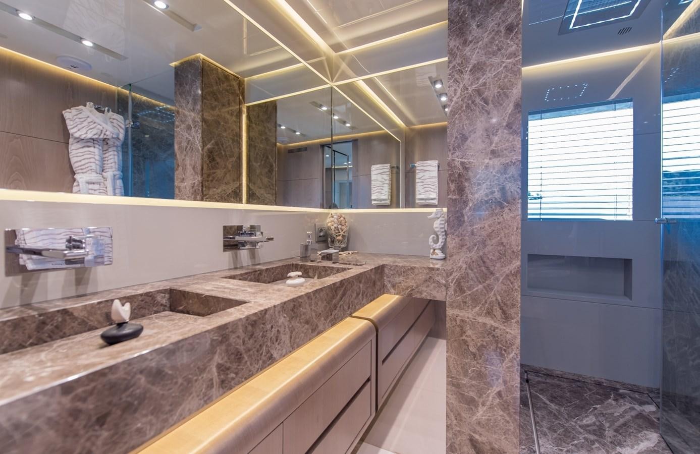 a bathroom with a countertop sink and a large mirror aboard 7 SECONDS Yacht for Sale