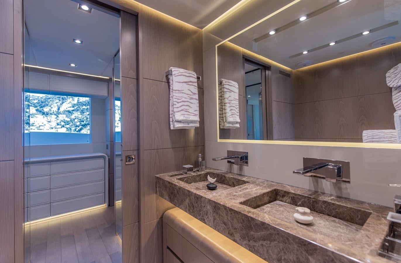 a bathroom with a countertop sink and a mirror aboard 7 SECONDS Yacht for Sale