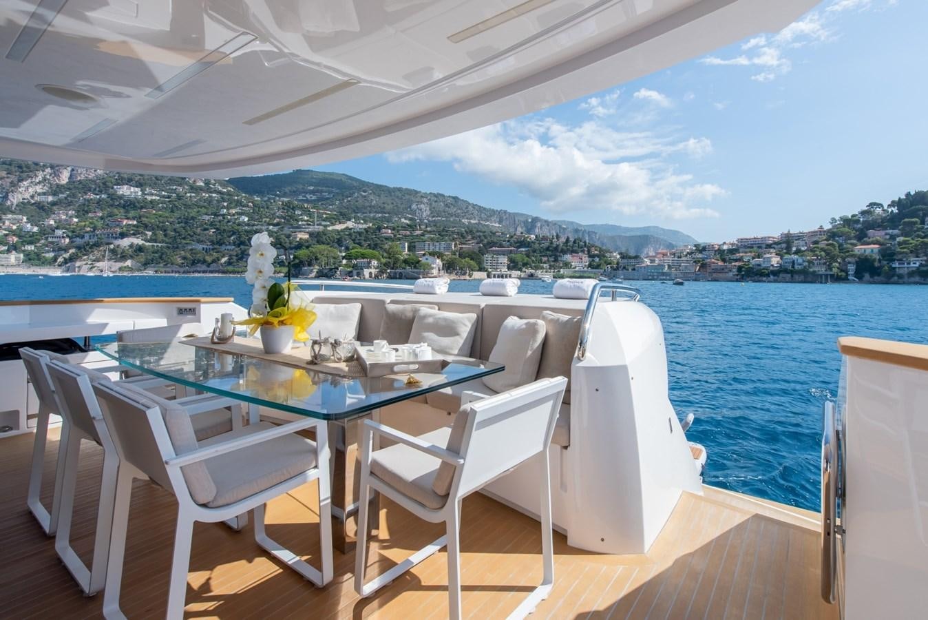 a table and chairs on a deck overlooking a body of water aboard 7 SECONDS Yacht for Sale