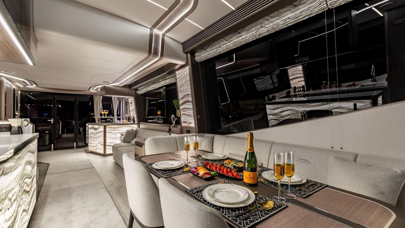 a table with plates and glasses on it aboard GALEON 800 FLY/1 Yacht for Sale