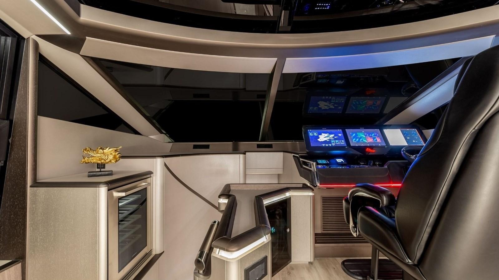 a room with a row of computer screens and a chair aboard GALEON 800 FLY/1 Yacht for Sale