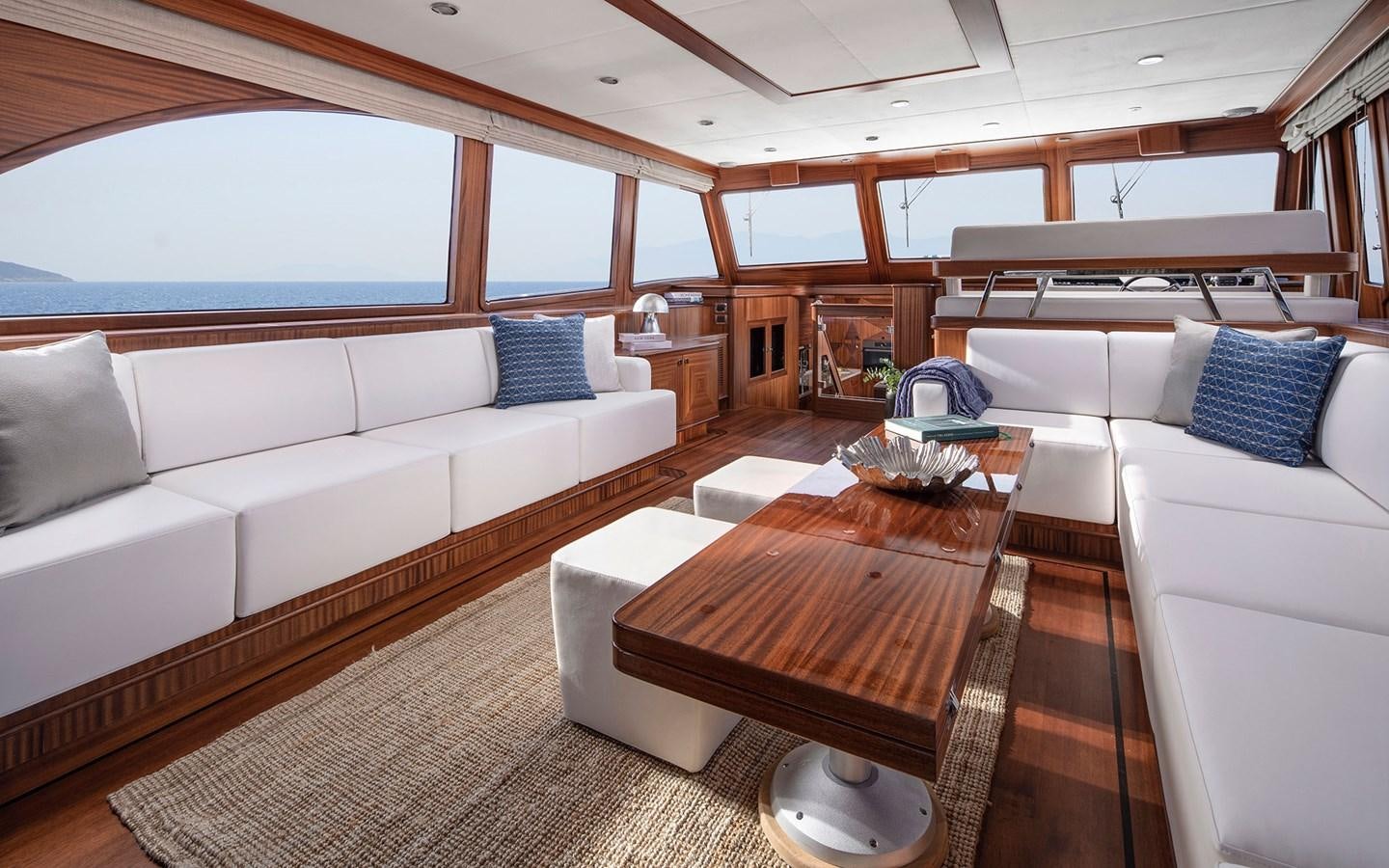 a room with a couch and a table aboard ALECTO Yacht for Sale