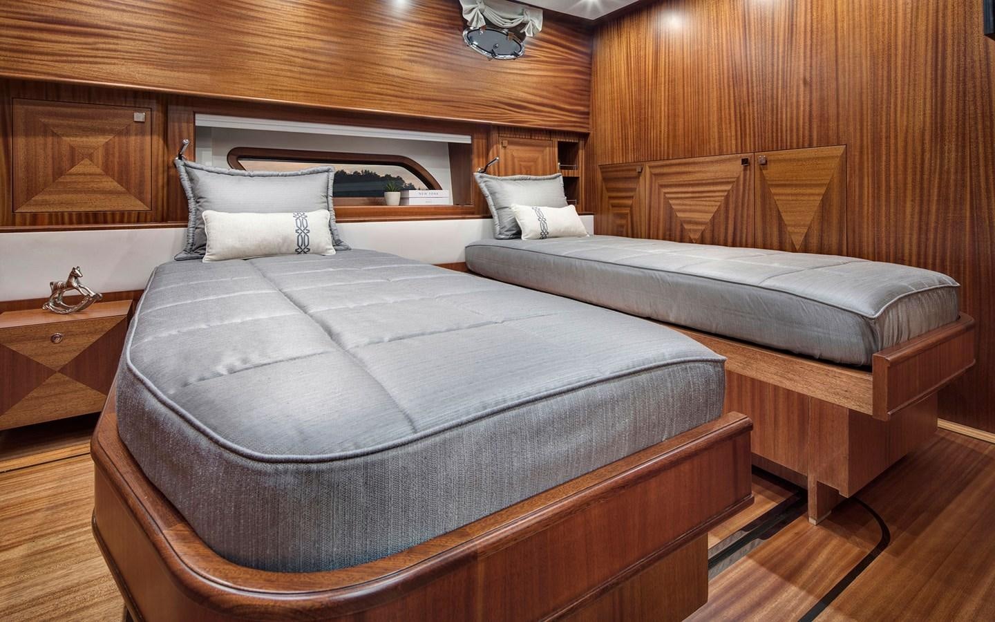 a bed with a blue sheet aboard ALECTO Yacht for Sale