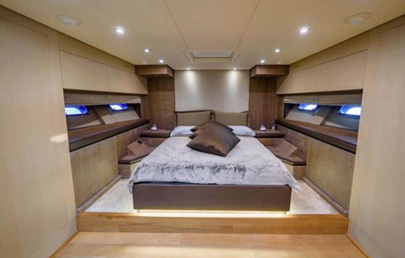 a room with a bed and a television aboard @LAST Yacht for Sale