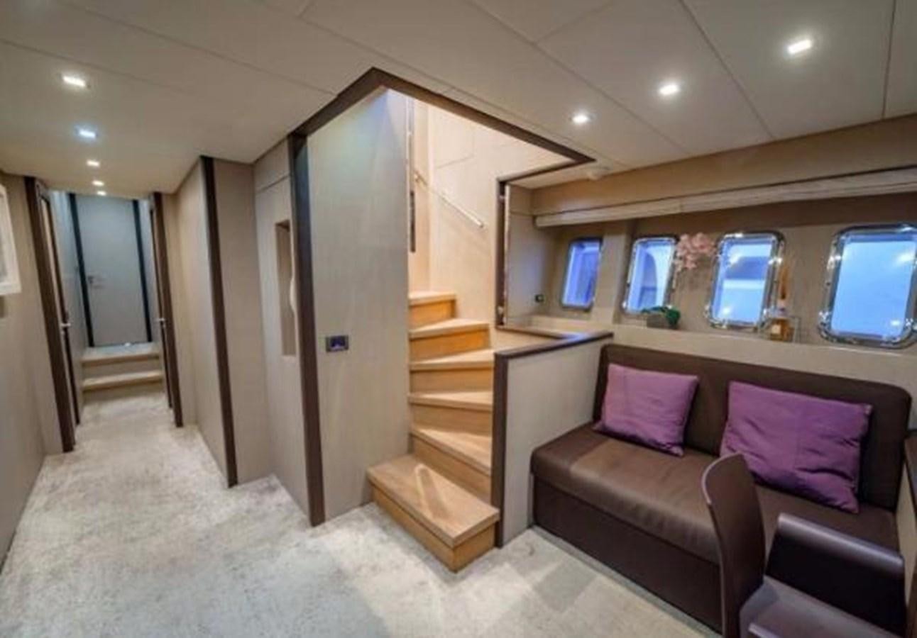 a living room with a staircase and a couch aboard @LAST Yacht for Sale
