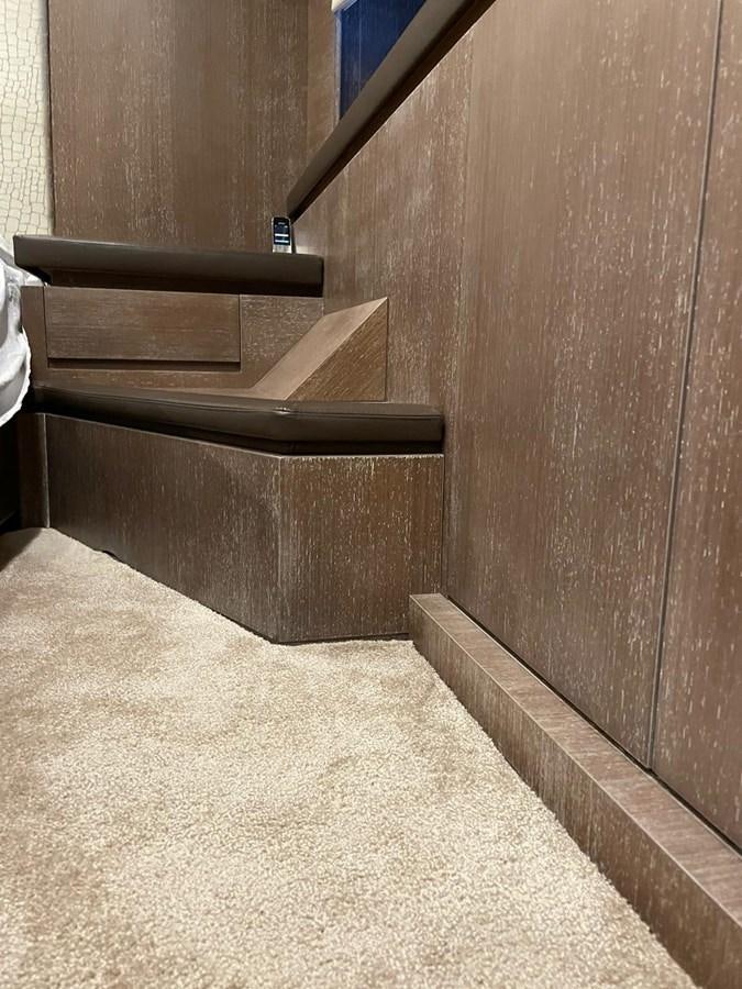 a wooden staircase with a wood railing aboard @LAST Yacht for Sale