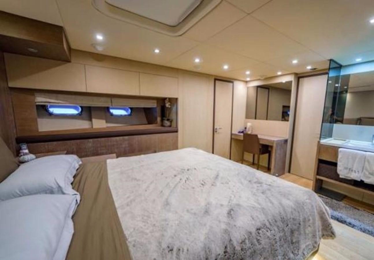 a bedroom with a bed and a mirror aboard @LAST Yacht for Sale