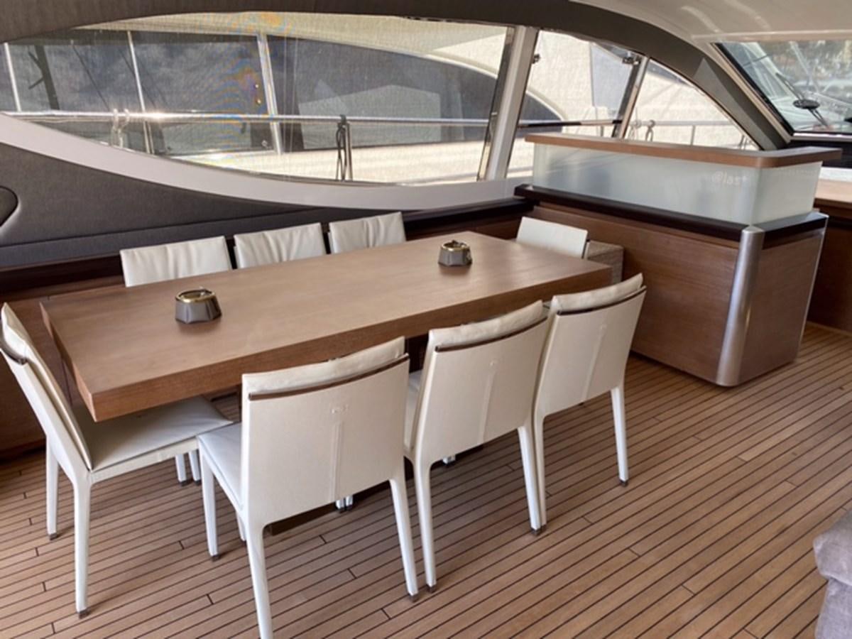 a table with chairs around it aboard @LAST Yacht for Sale