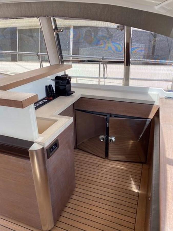 a wooden desk with a camera on it aboard @LAST Yacht for Sale
