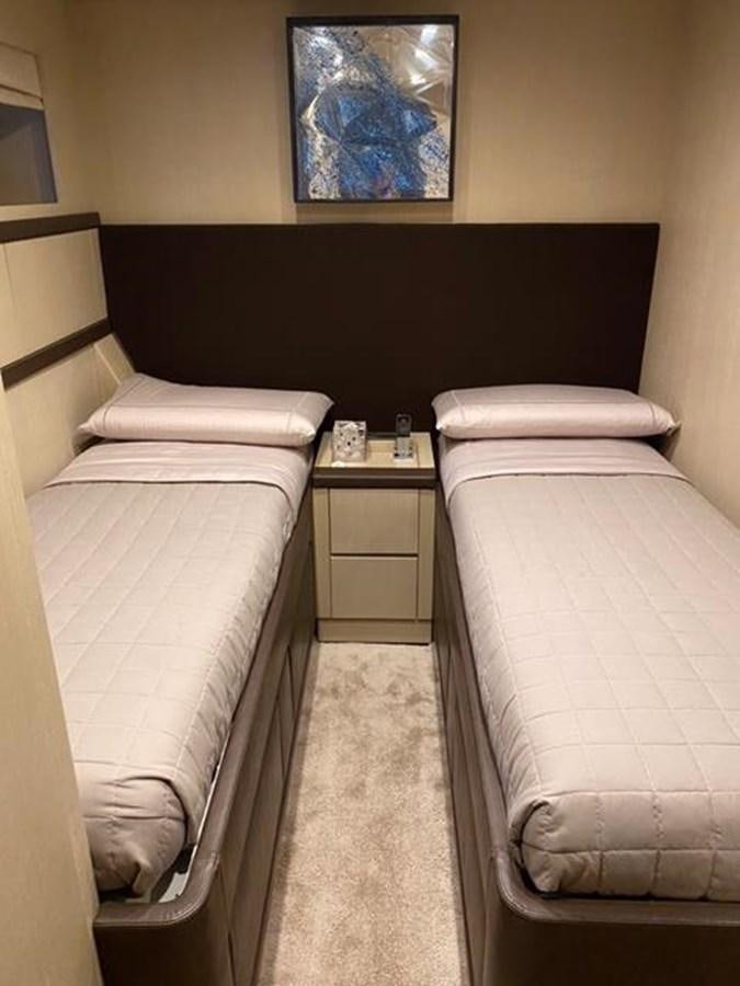 a bed with a wooden headboard aboard @LAST Yacht for Sale