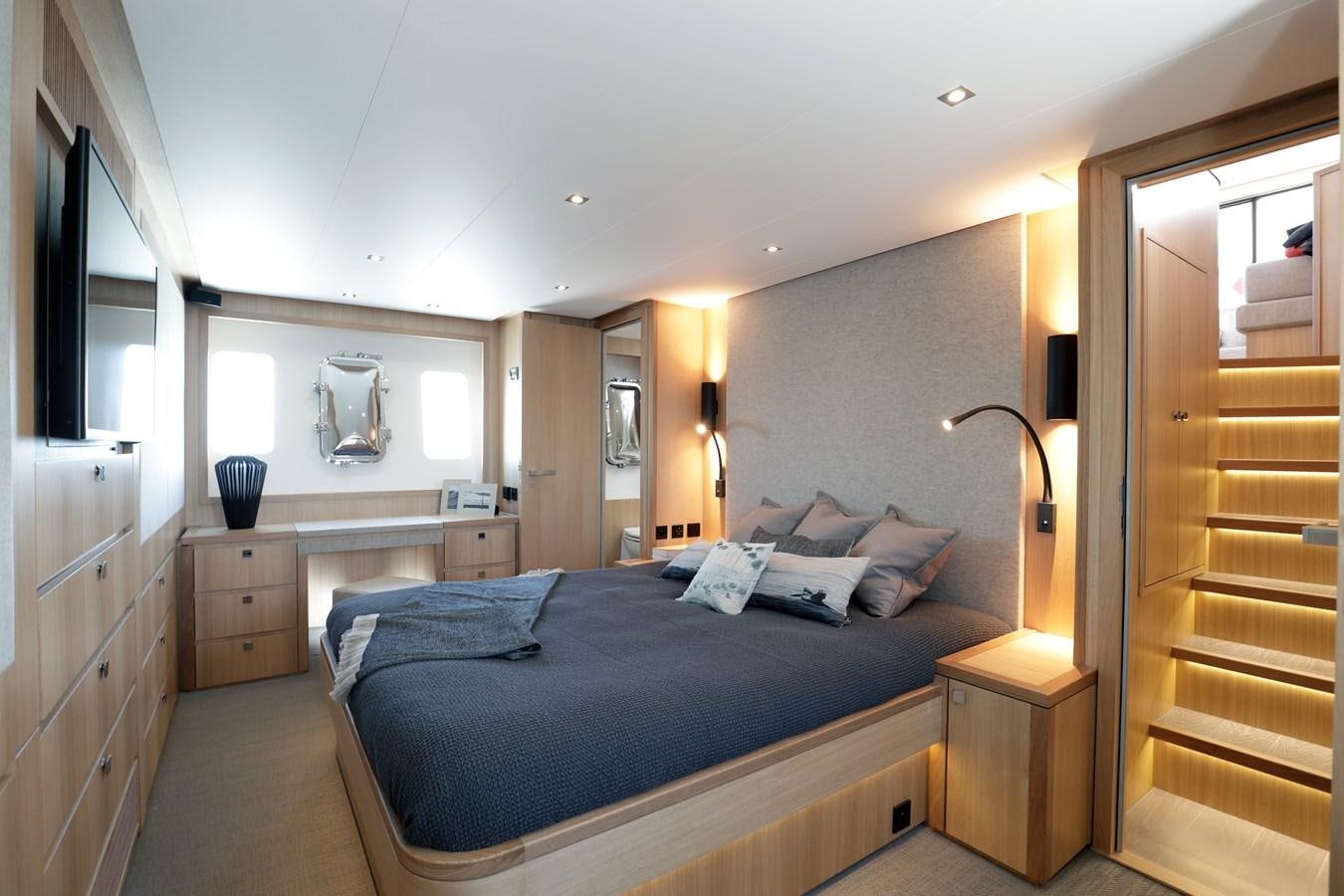 a bedroom with a bed and a closet aboard ARMONEE Yacht for Sale