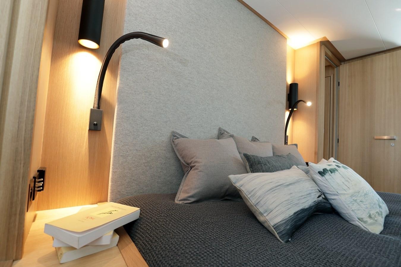 a bed with a lamp on it aboard ARMONEE Yacht for Sale