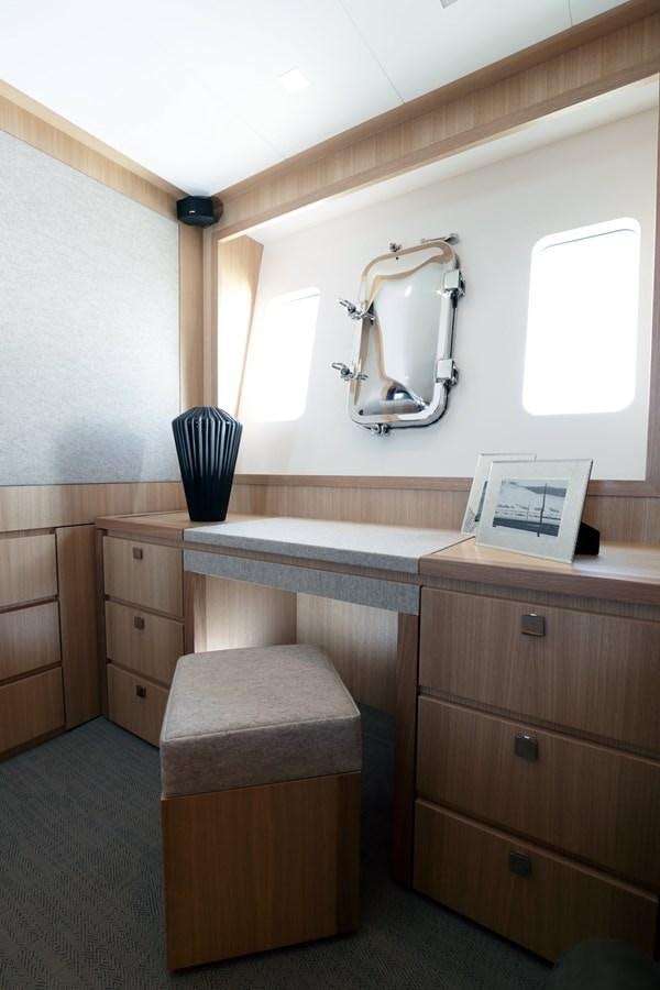 a desk with a lamp and a laptop on it aboard ARMONEE Yacht for Sale
