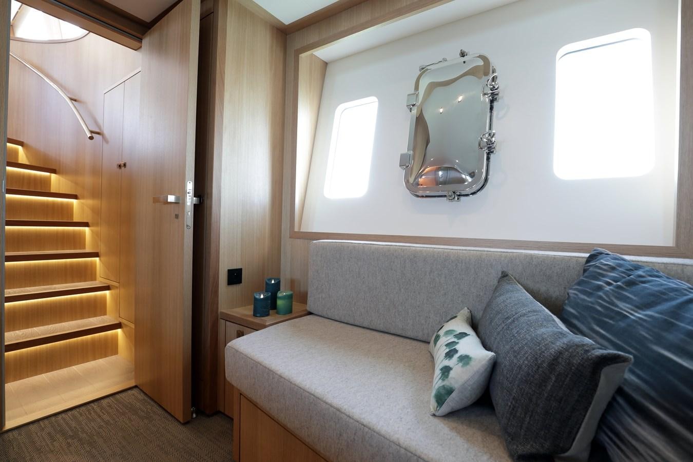a couch and a mirror in a room aboard ARMONEE Yacht for Sale