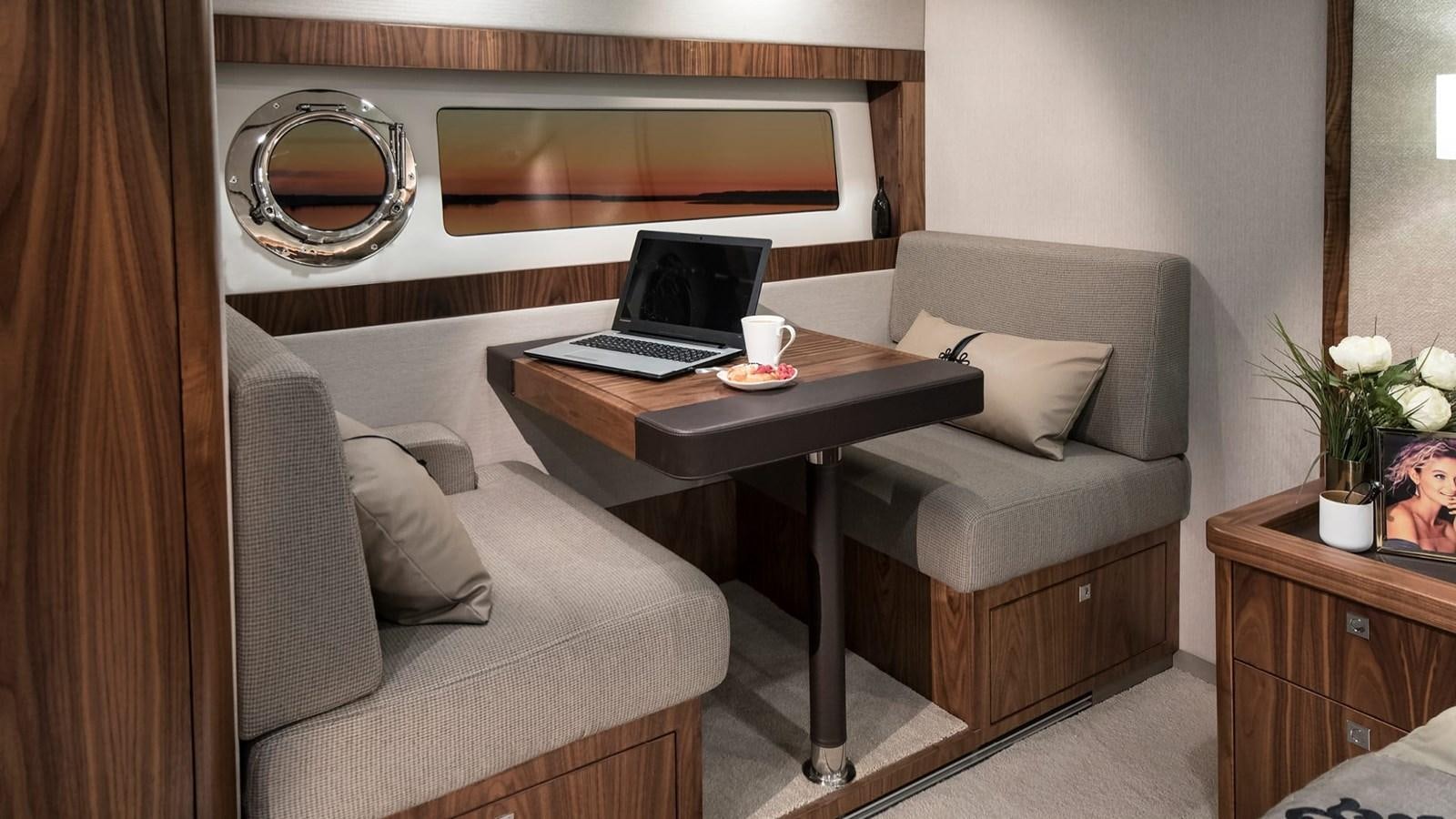 a living room with a couch and a coffee table aboard 68 SPORTS MOTOR YACHT Yacht for Sale