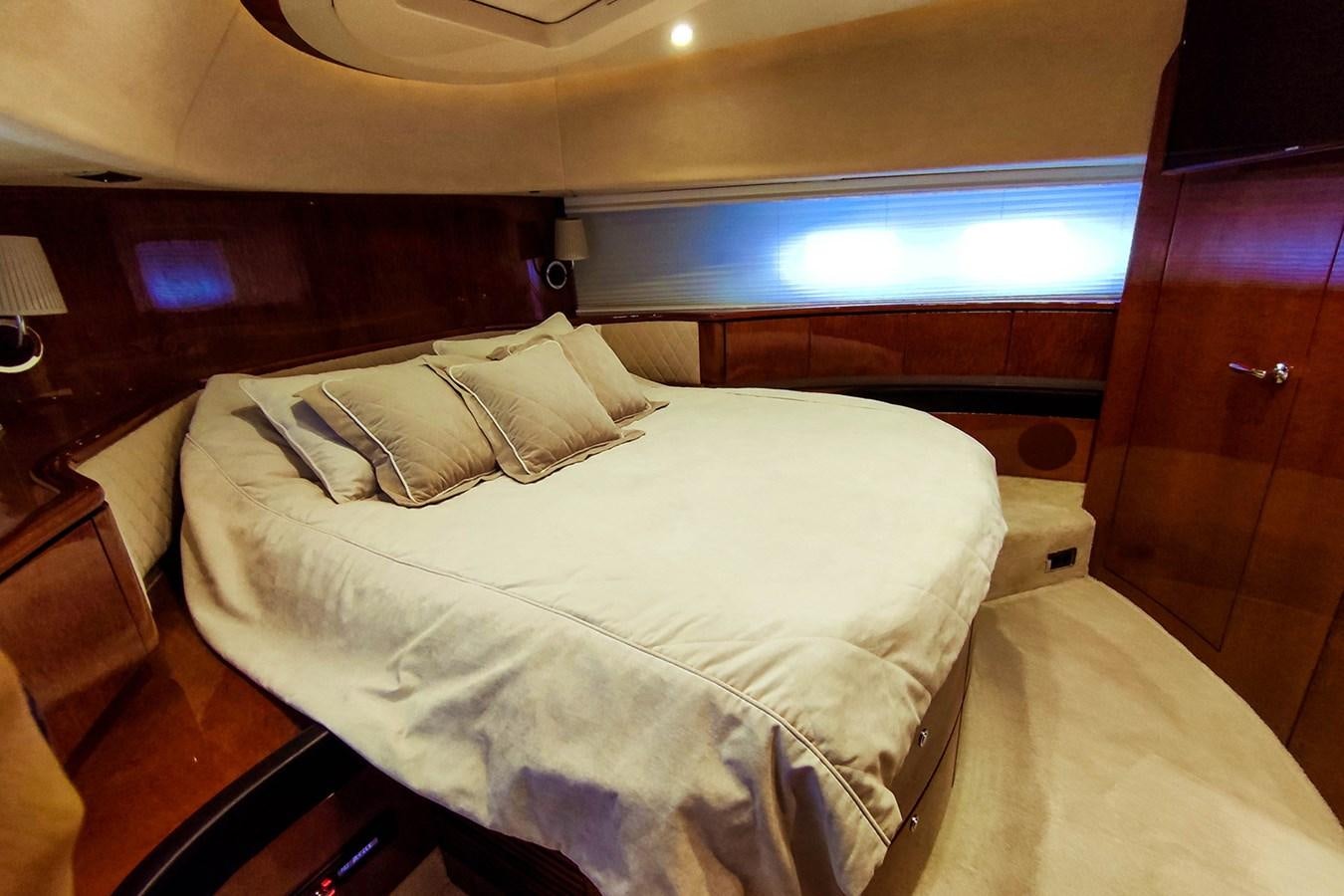 a bed with a white sheet aboard SEVEN Yacht for Sale