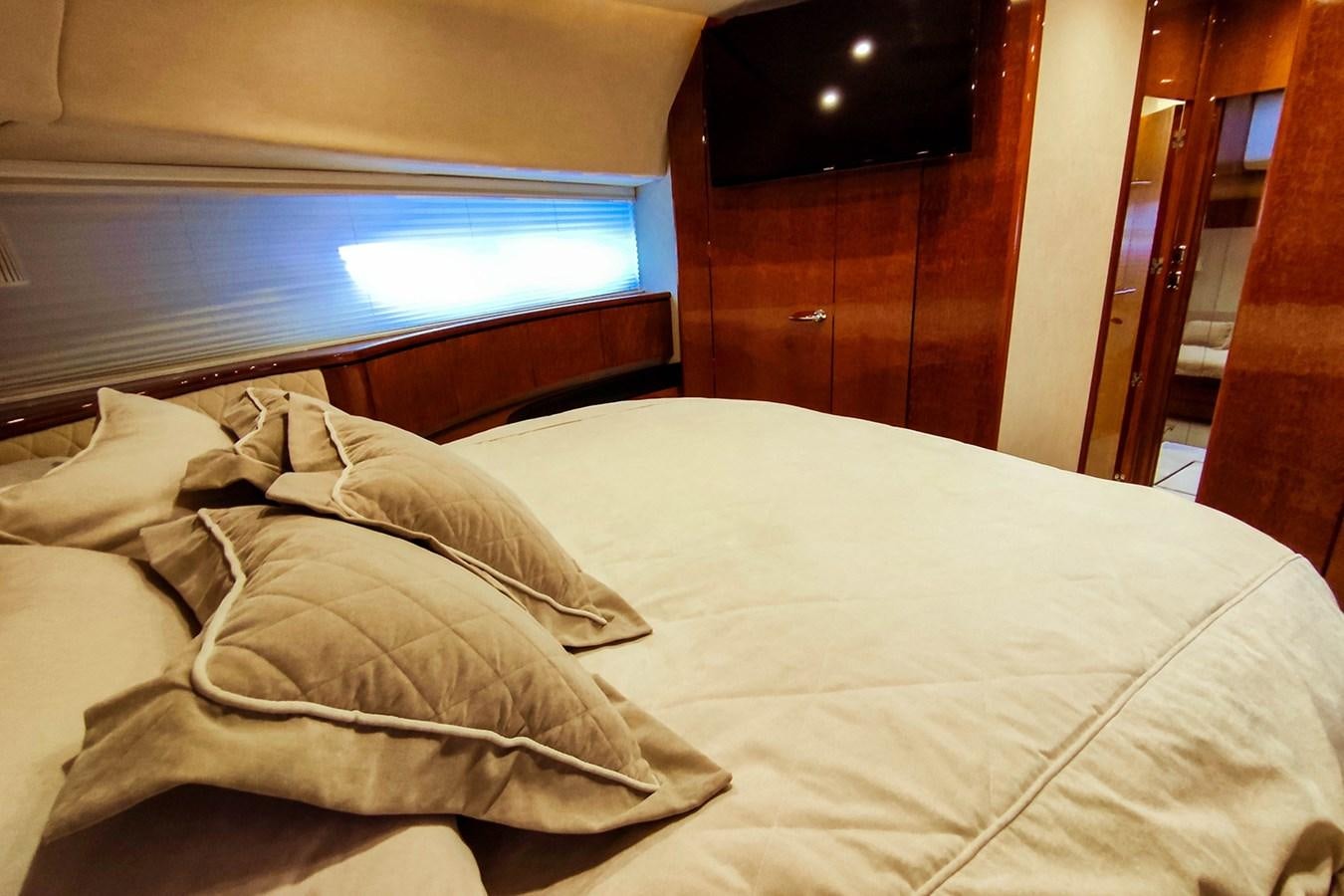 a bed with white sheets aboard SEVEN Yacht for Sale