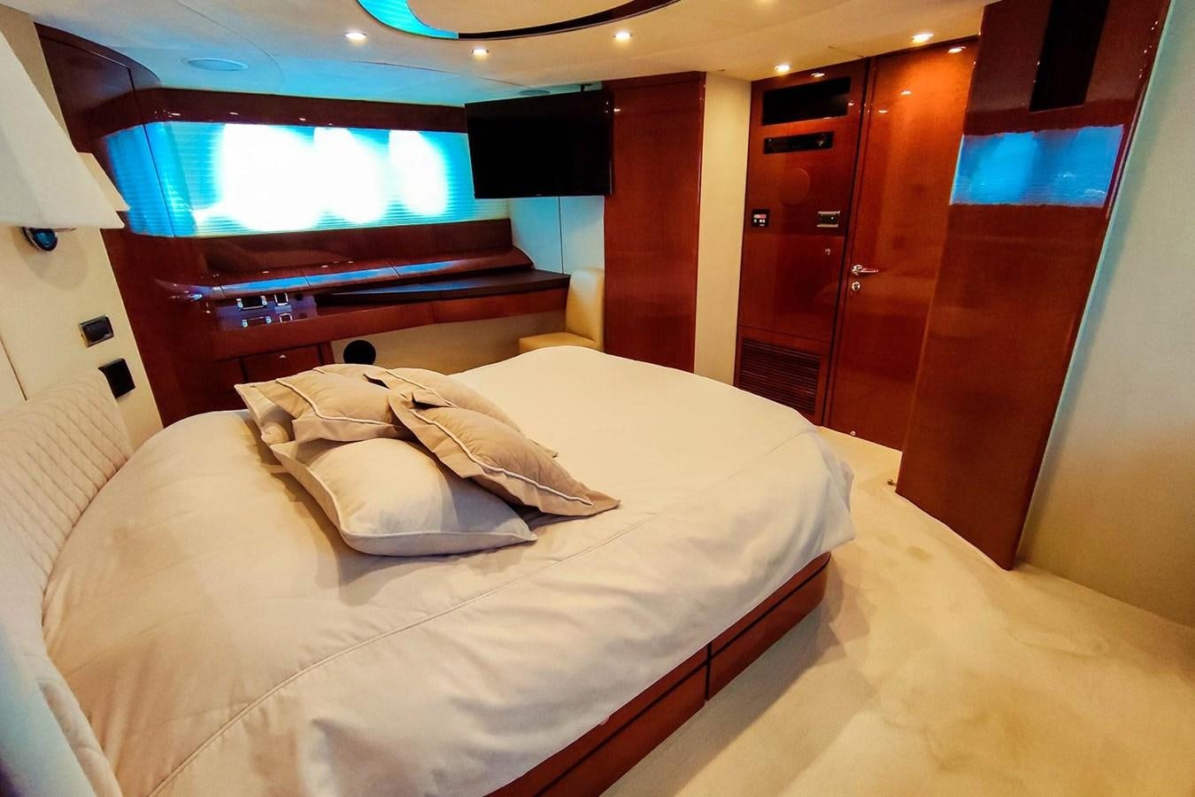 a room with a bed and a television aboard SEVEN Yacht for Sale