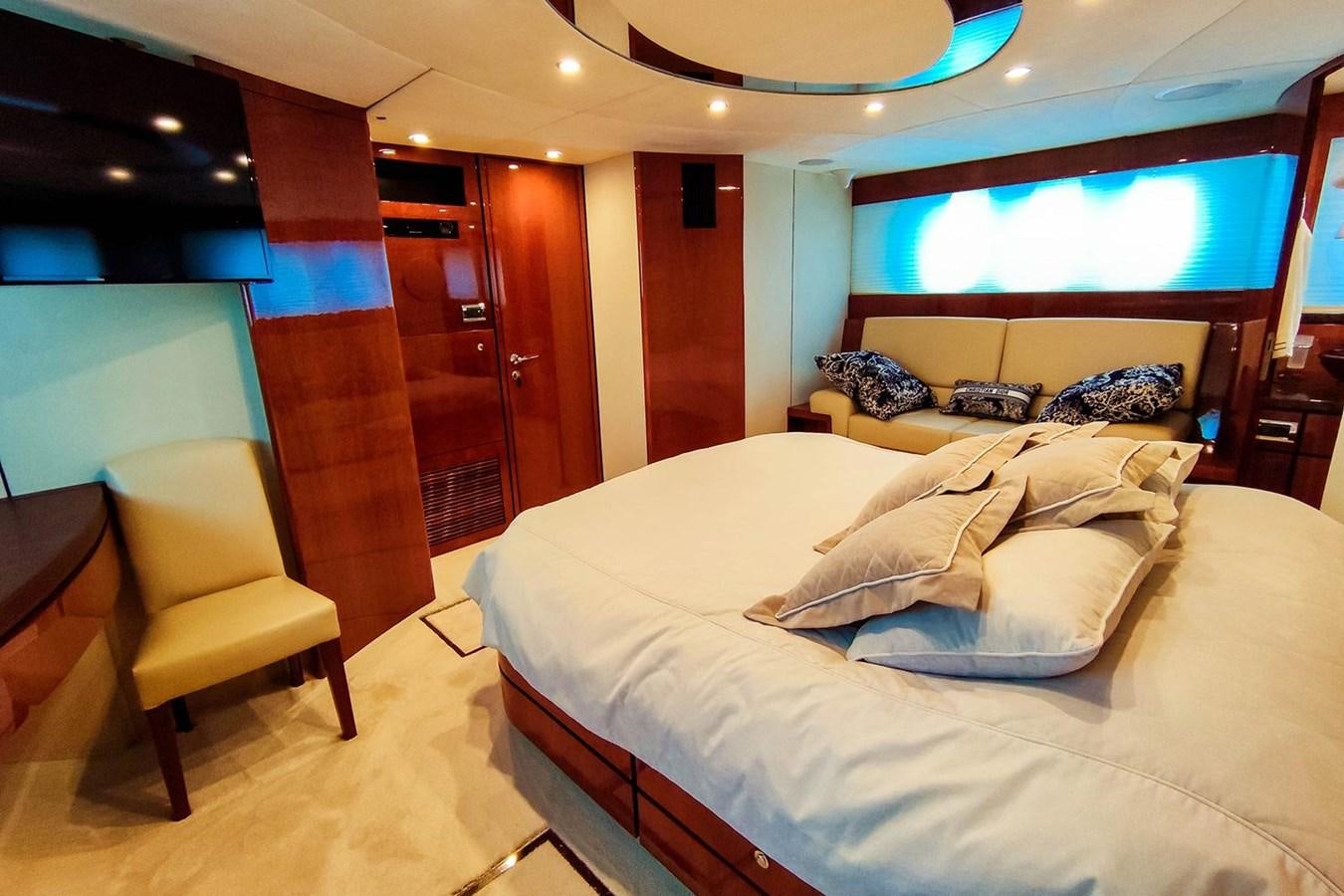a room with a bed and a chair aboard SEVEN Yacht for Sale