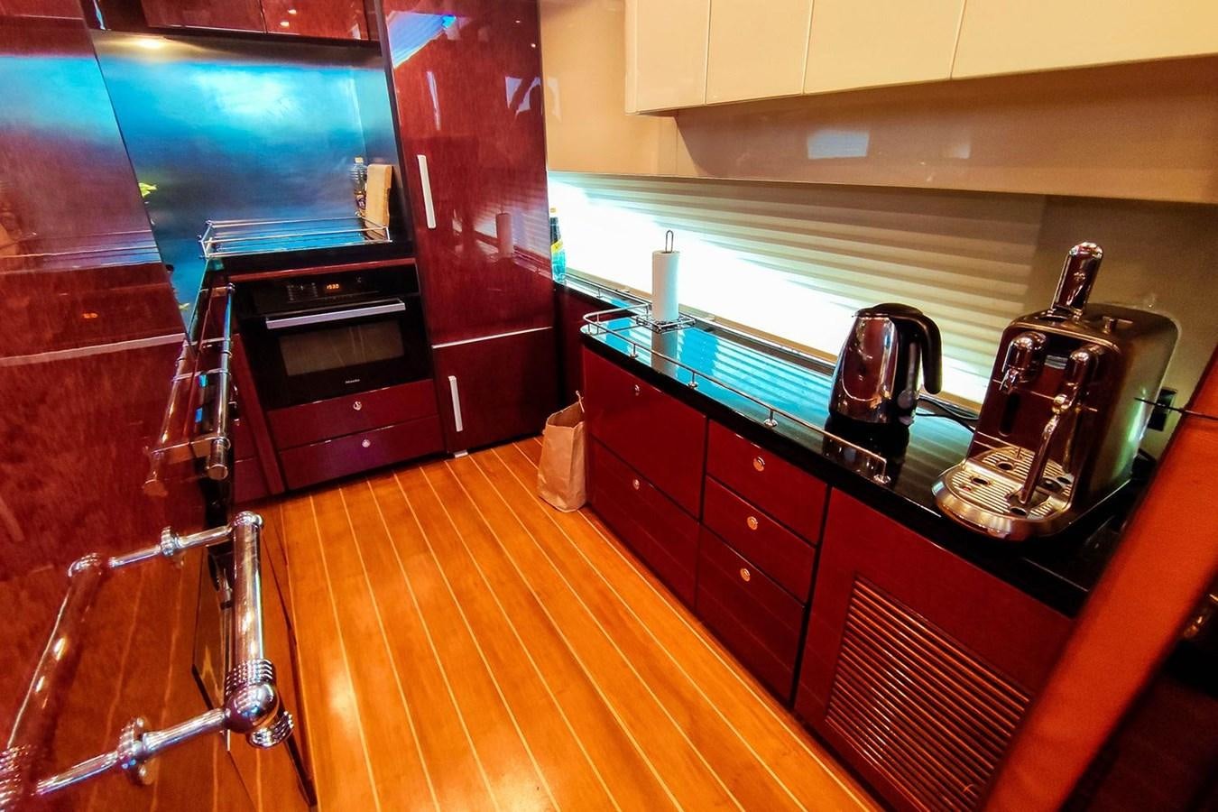 a kitchen with a stove and a microwave aboard SEVEN Yacht for Sale
