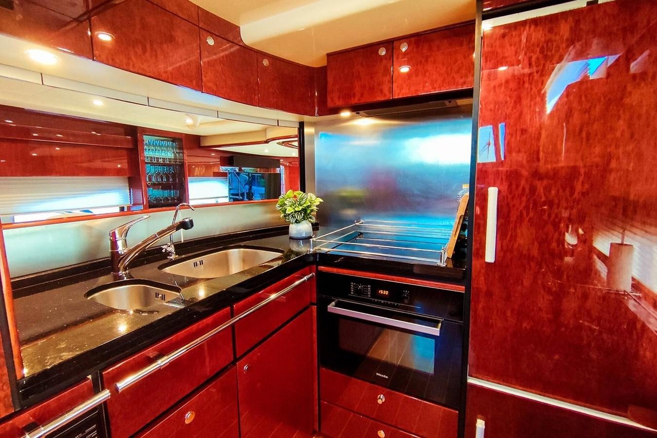 a kitchen with a tv and a sink aboard SEVEN Yacht for Sale
