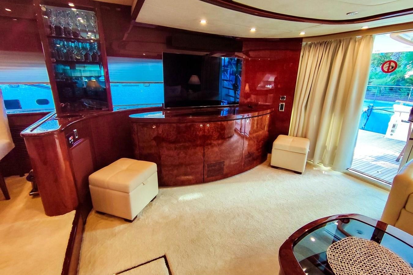 a living room with a bar and a tv aboard SEVEN Yacht for Sale