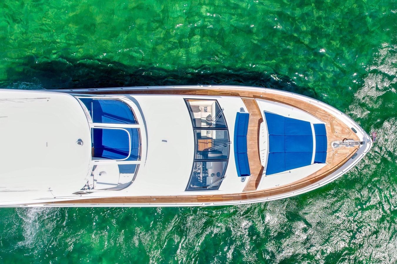 a small white boat on the water aboard SUNSEEKER 73 2013 Yacht for Sale