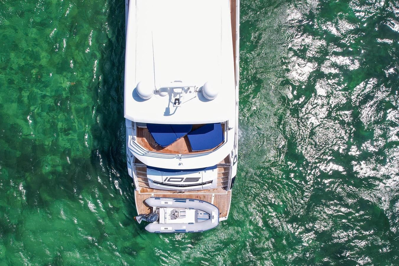 a white and blue boat on a green water body aboard SUNSEEKER 73 2013 Yacht for Sale