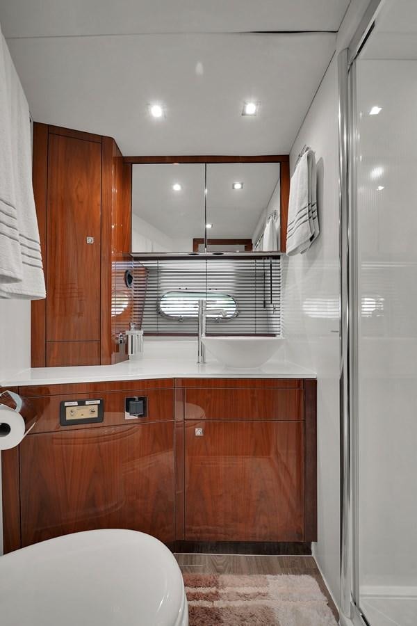 a bathroom with a glass shower aboard SUNSEEKER 73 2013 Yacht for Sale